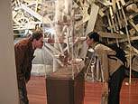 University students view 3-dimensional photographs of flood-era Johnstown, at the Johnstown Flood Museum.